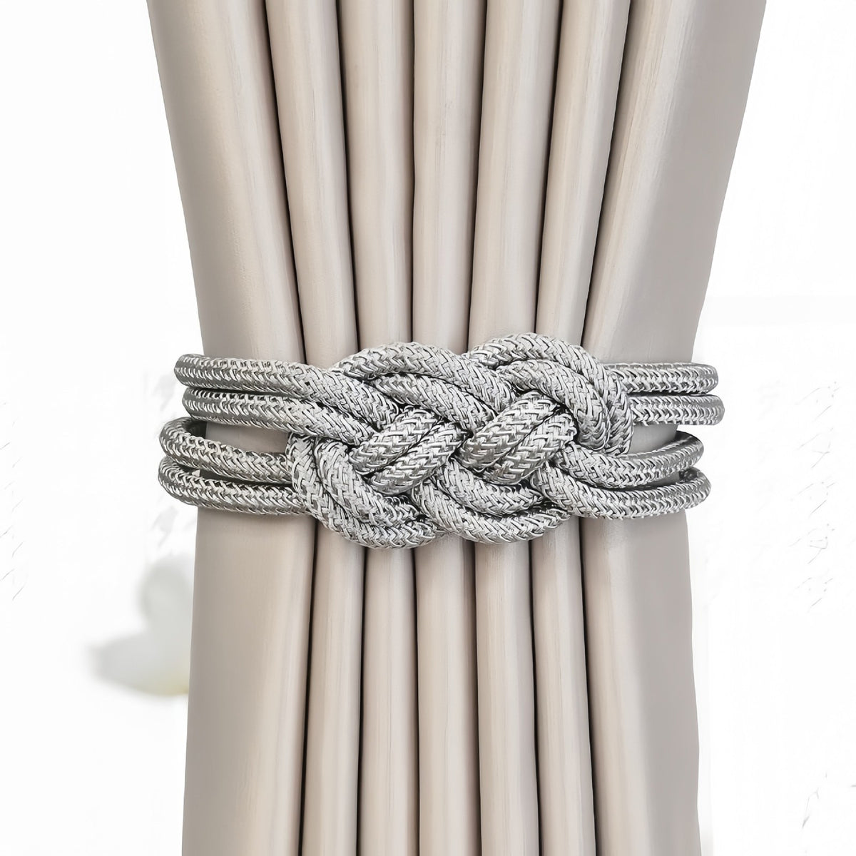 Tieback holding beige curtains